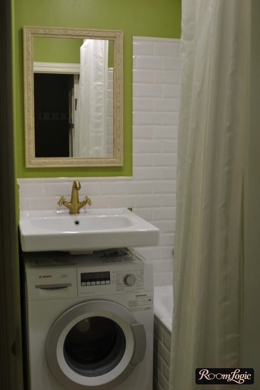 combination of white and green colors in the bathroom of a tiny apartment