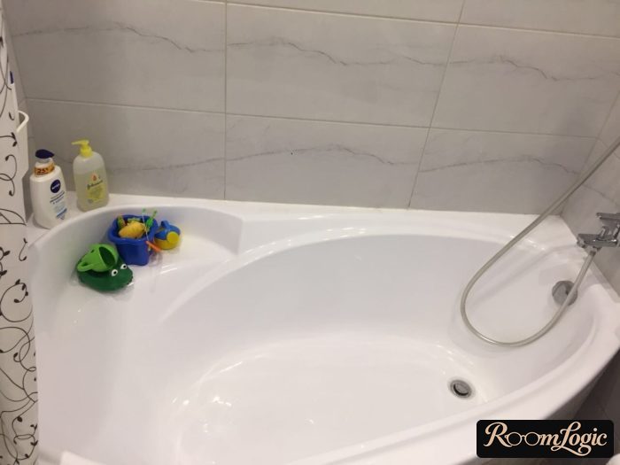 corner bathtub in tiny apartment