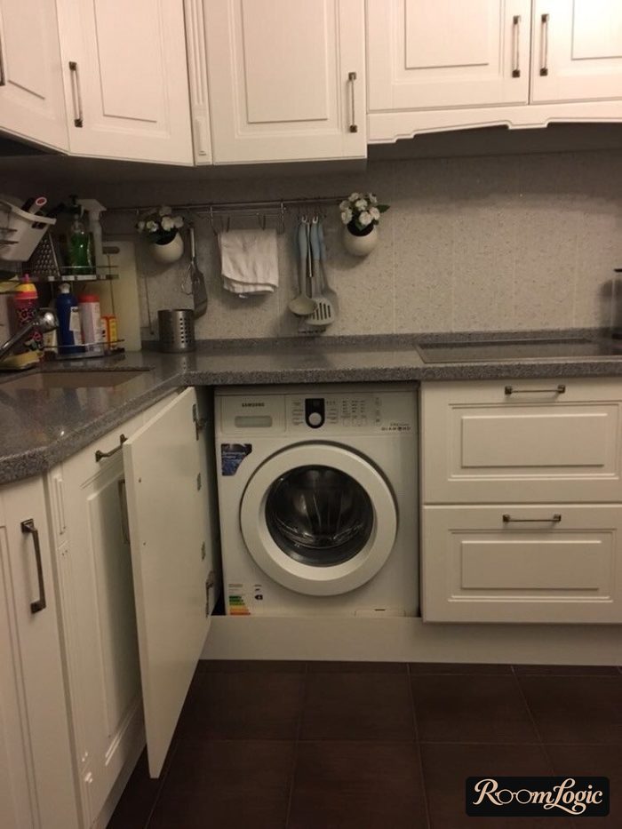 corner kitchen with a washer in provence style
