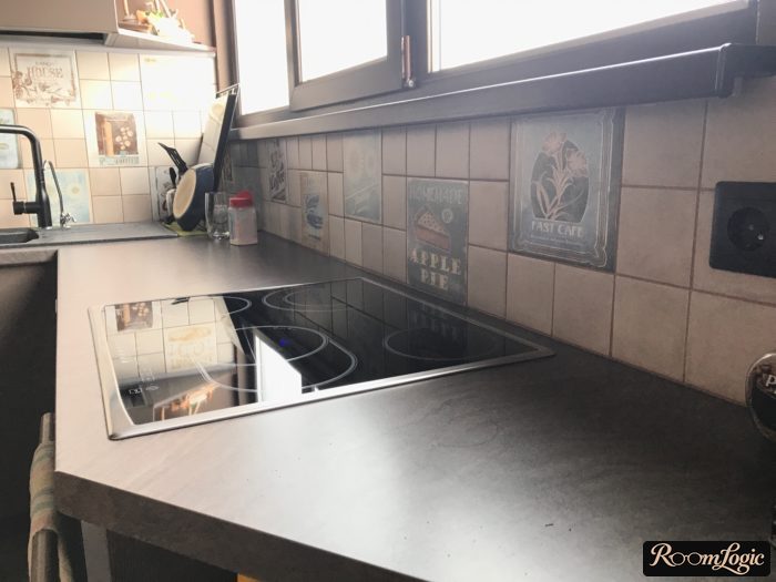 corner kitchen with a window behind the stove