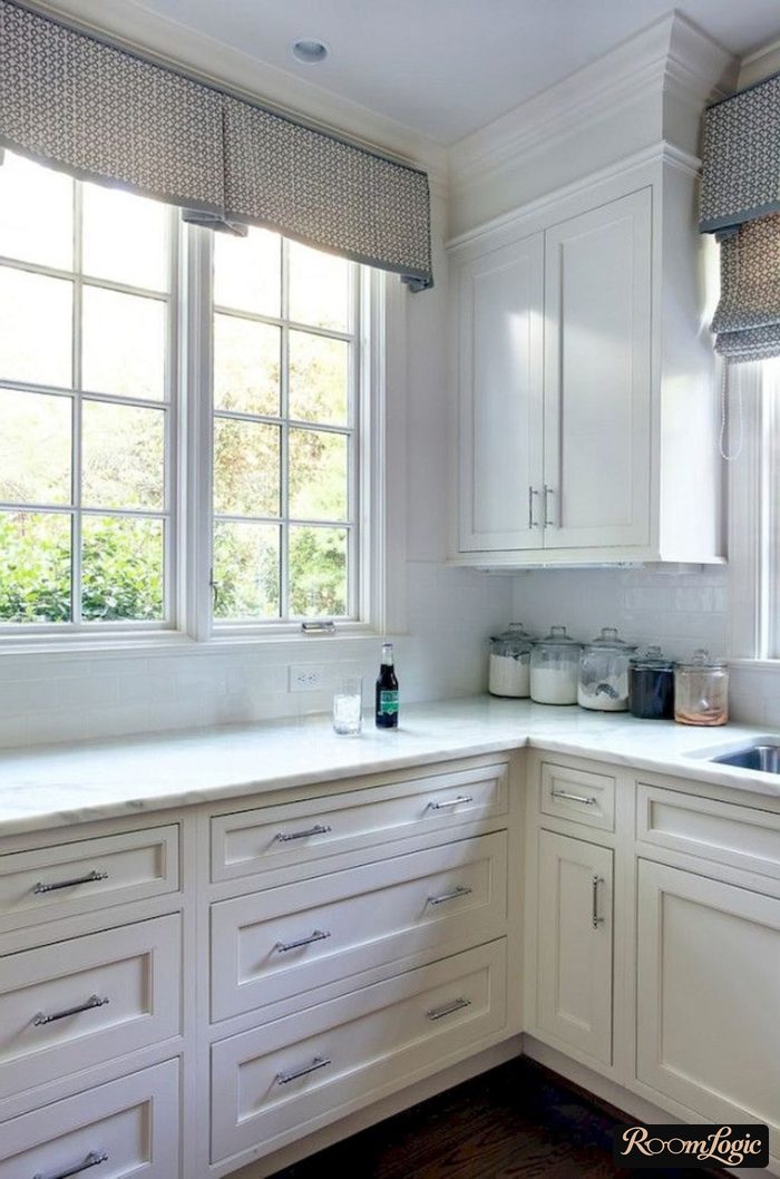 corner white kitchen with a window in neoclassical style
