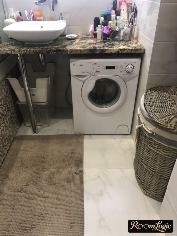 countertop with sink over washer