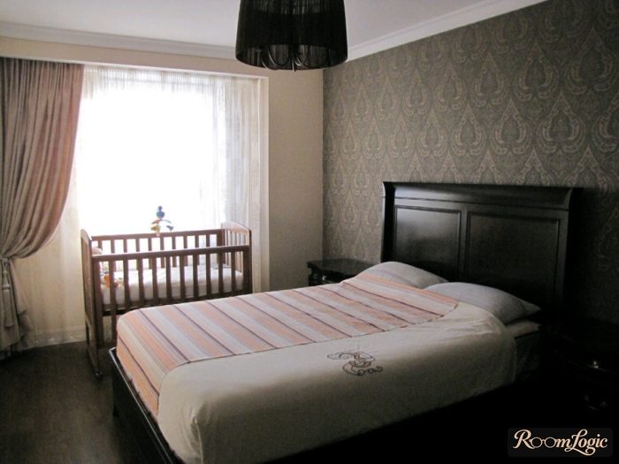crib near the window in the bedroom