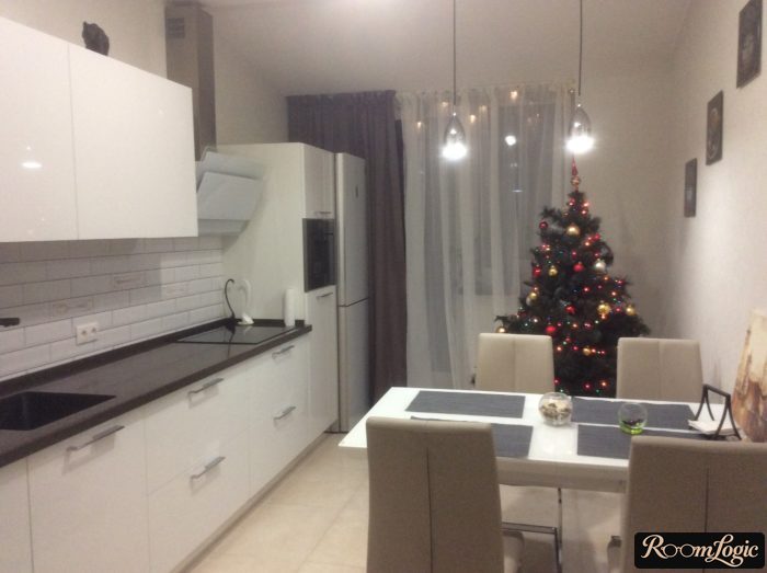 Curtains on one side and a sheer curtain in the middle in a white kitchen with a balcony door