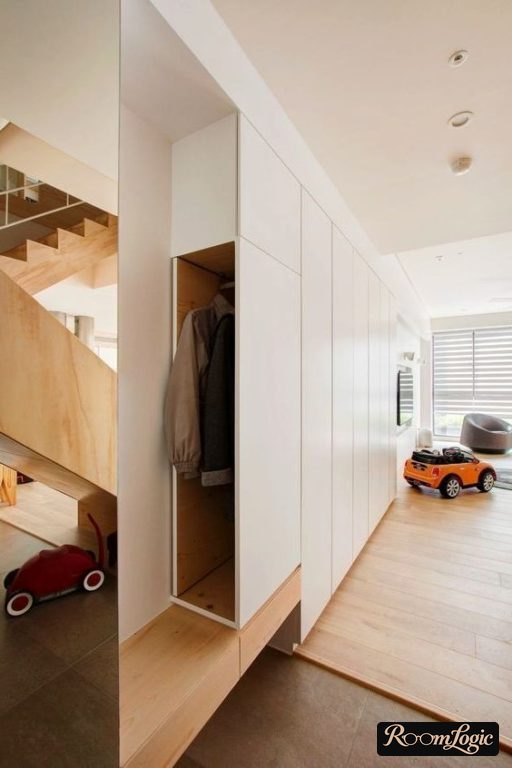 custom-made white narrow closet in the hallway