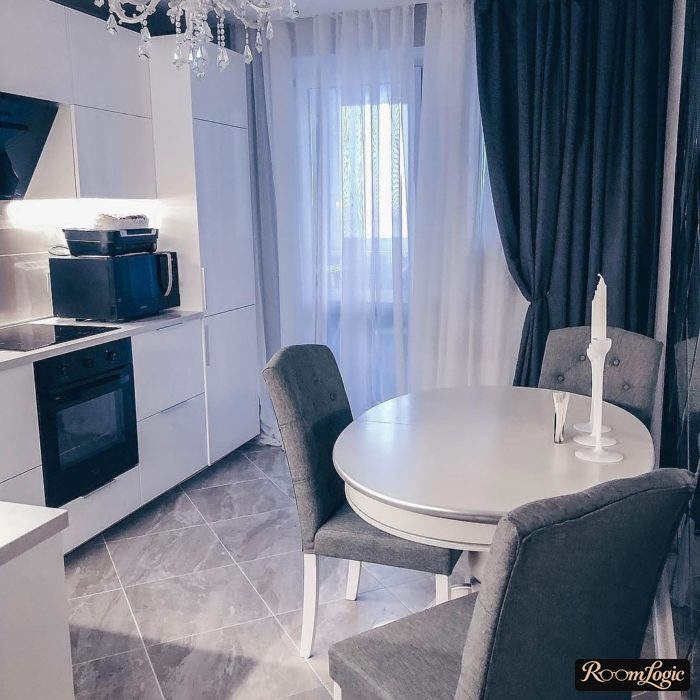 dark blue curtains on a white kitchen with a balcony door