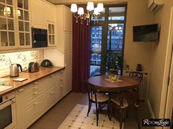 dark brown wooden countertop in a white kitchen in a classical style