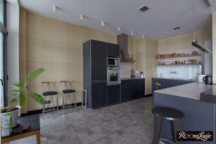 Dark gray concrete-look tile on the floor in the black kitchen