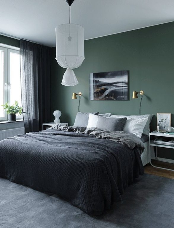 dark green wall behind the bed