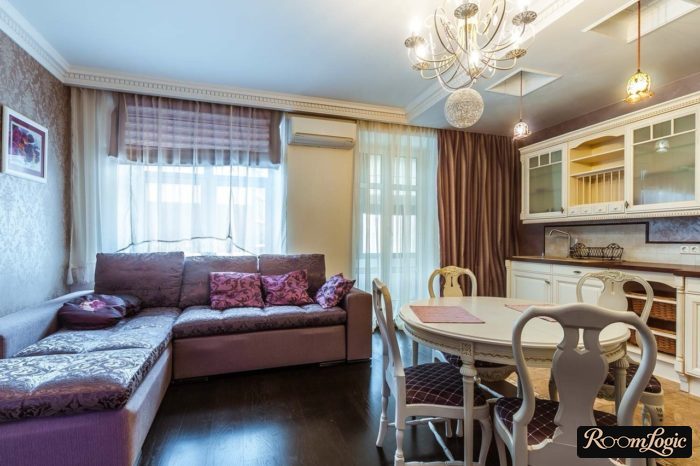 dark orange curtains in a kitchen-living room with a balcony door