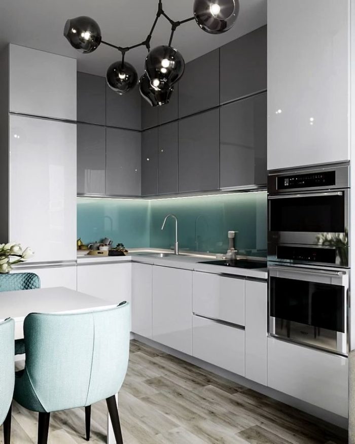 design of a small white kitchen with a glass backsplash