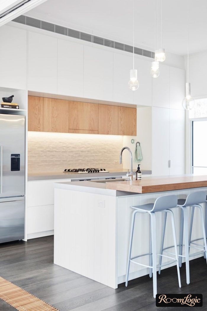 design of a white kitchen with an island and wooden inserts