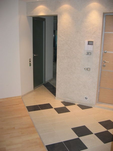 diagonal tile joint next to the door with laminate