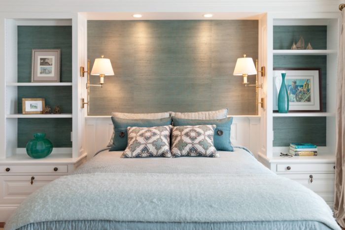 dressers with shelves next to the bed