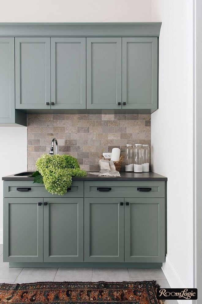 dusty blue kitchen cabinets and white walls in a neoclassical style