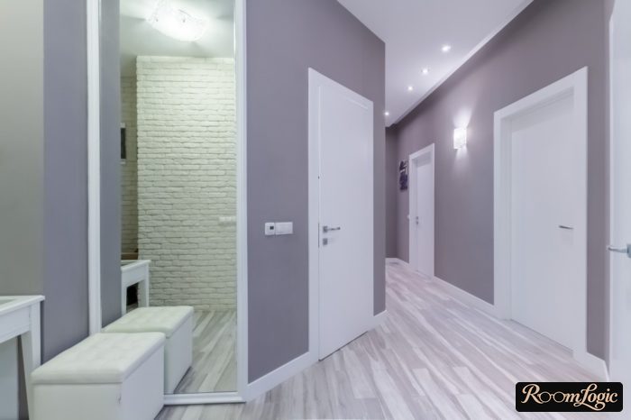 entryway in gray and white tones with a large mirror