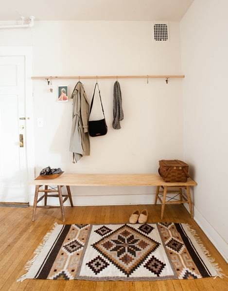 entryway with a bench and coatrack