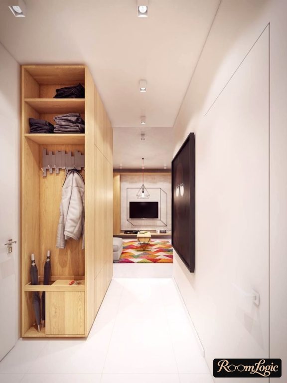 entryway with open shelves and hooks at the end of a small hallway
