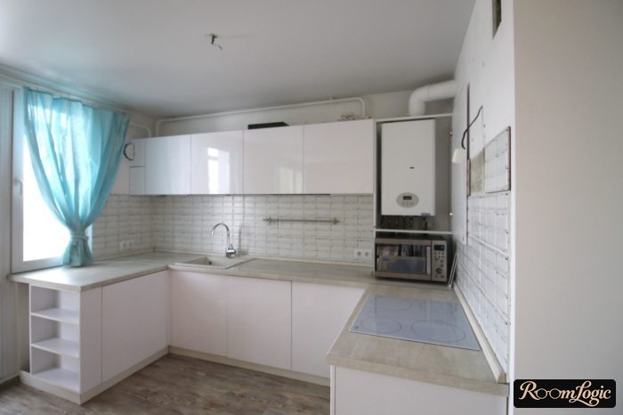 example white kitchen cabinets with a gas stove area