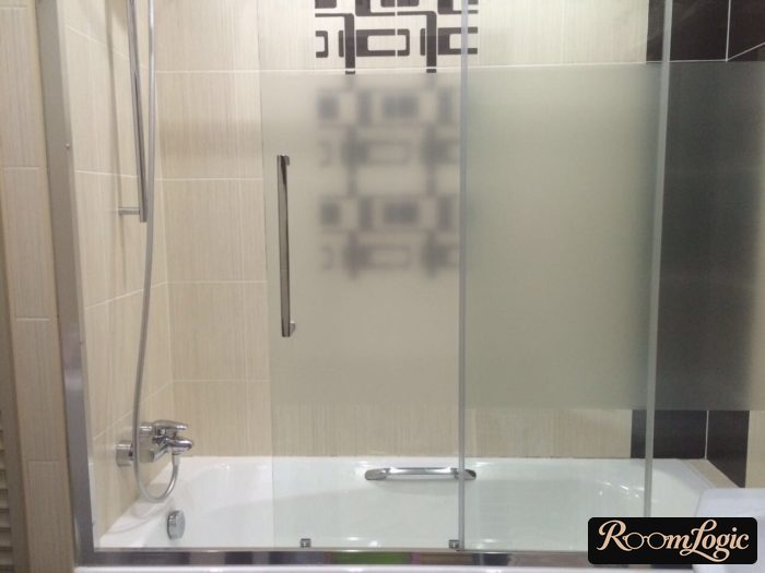 glass door on the bathtub in a tiny apartment