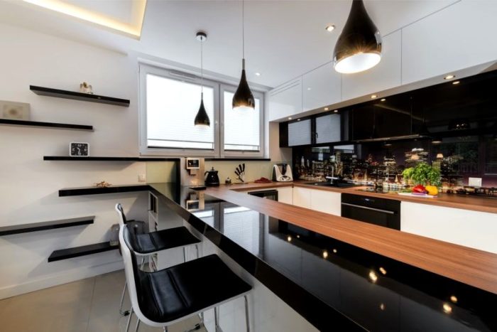 Glossy black and white kitchen with a breakfast bar
