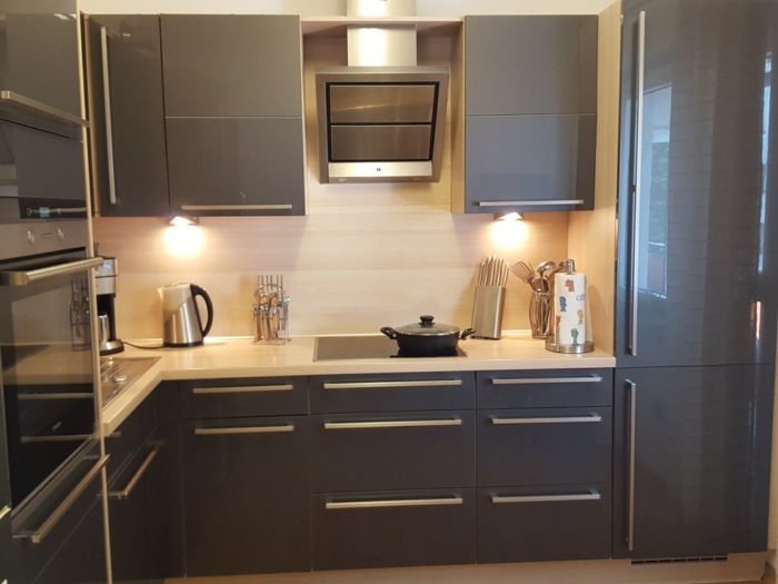 Glossy gray cabinet fronts in a small kitchen