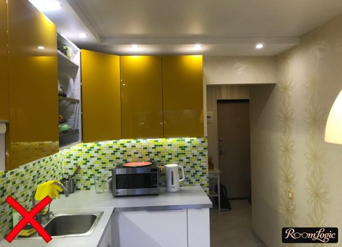 Glossy orange kitchen with beige wallpaper featuring a floral pattern