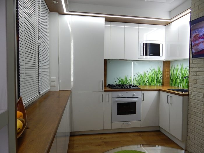 Glossy white kitchen with a countertop over the window