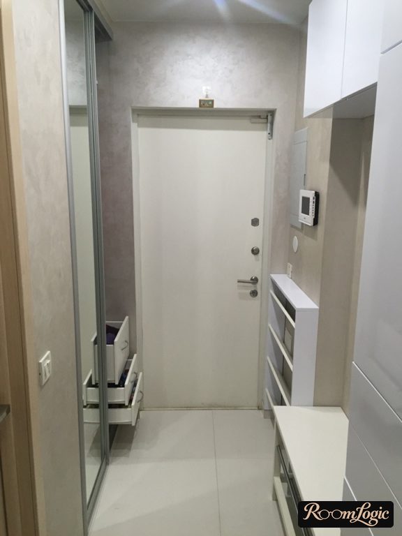 Glossy white modular furniture in a narrow hallway