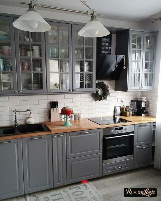 Graphite-colored kitchen with transparent upper cabinets in a neoclassical style
