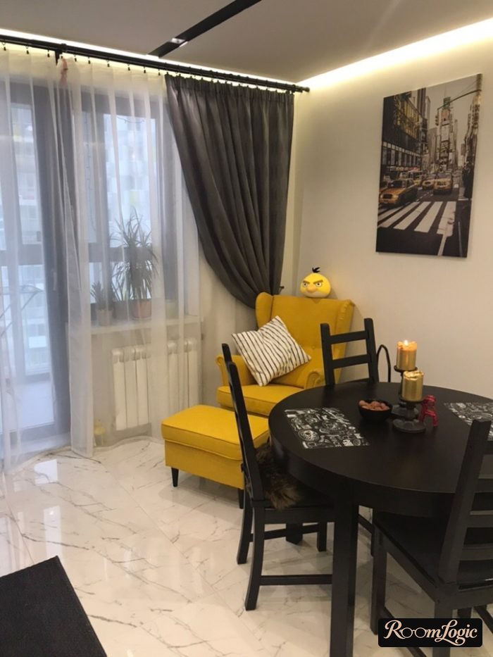 gray curtains on a wall rod in a kitchen with a balcony