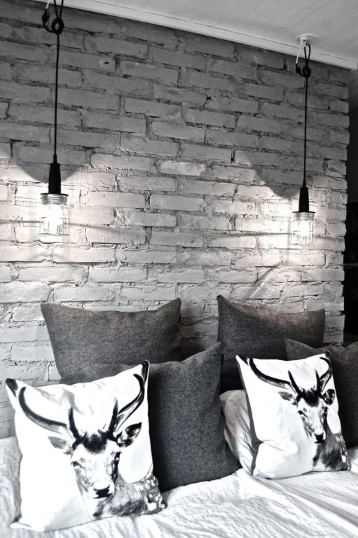 gray painted brick behind the bed
