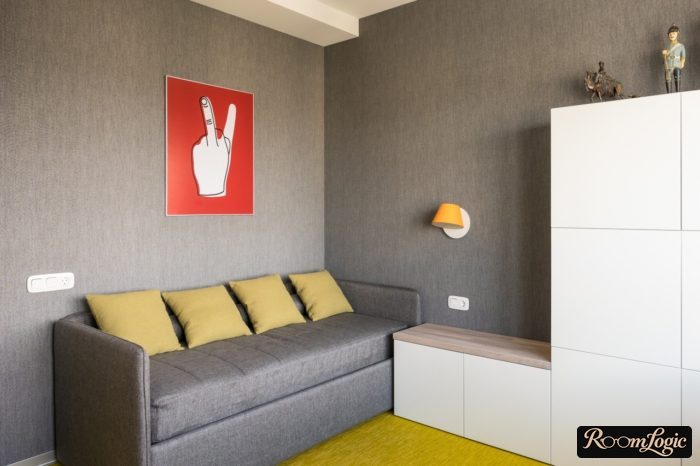 Gray wallpaper and a red poster in a teenager's room