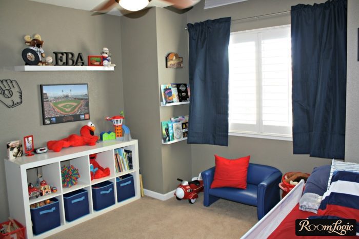 Gray wallpaper, white shelves, and blue curtains in the boys' room