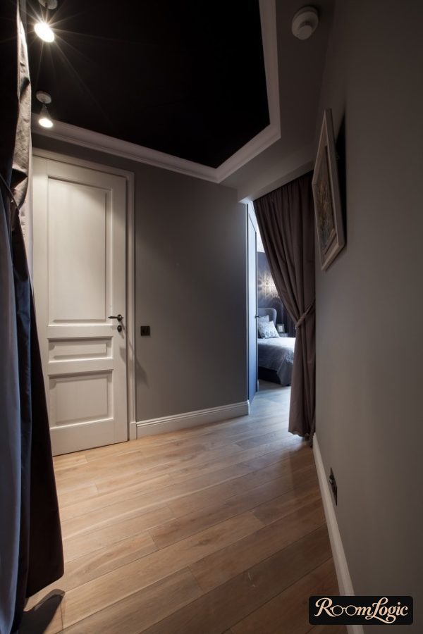 hallway with gray walls and black ceiling