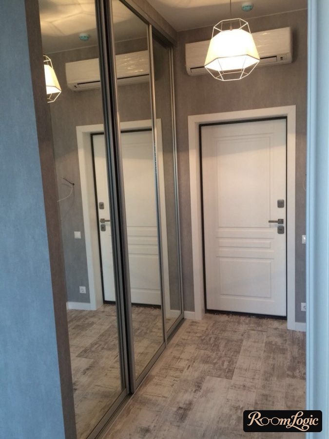 hallway with mirrored closet