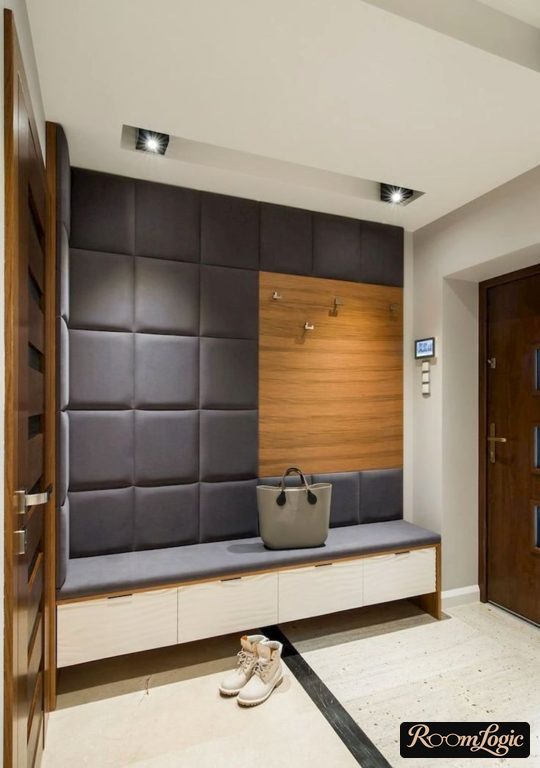 hangers for coats and a bench with shoe drawers in a small hallway