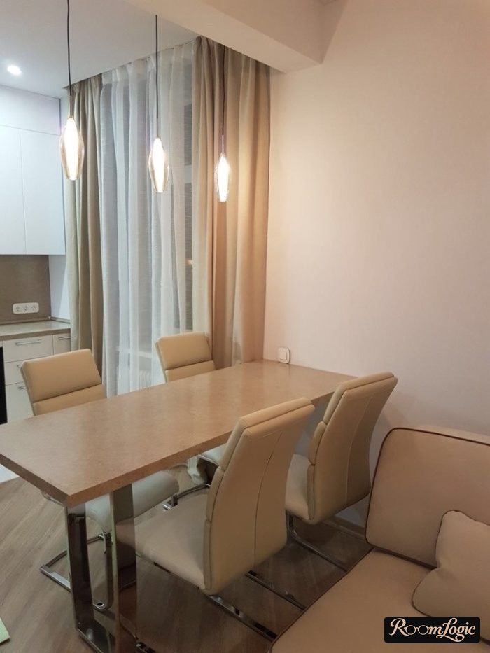 hanging lights above the table in the kitchen-living room