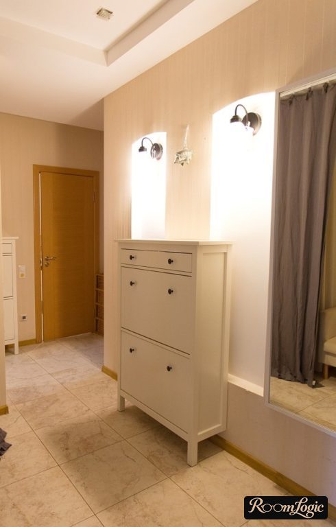 High narrow sideboard on legs in the hallway