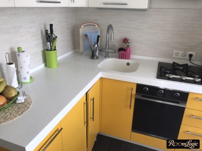 hinged doors below on the corner of the kitchen cabinets