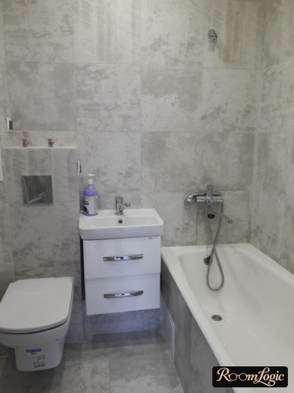 interior of a small bathroom with gray matte tile