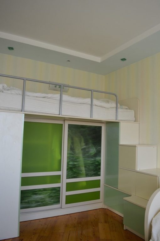 kids' room bed above closet