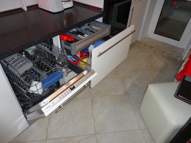 Kitchen cabinets with a built-in dishwasher and pull-out drawers