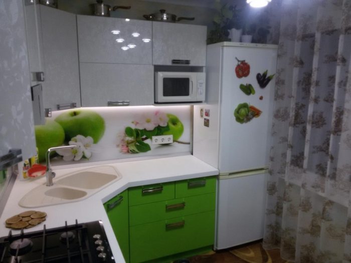 kitchen design in a tiny apartment with refrigerator by the window