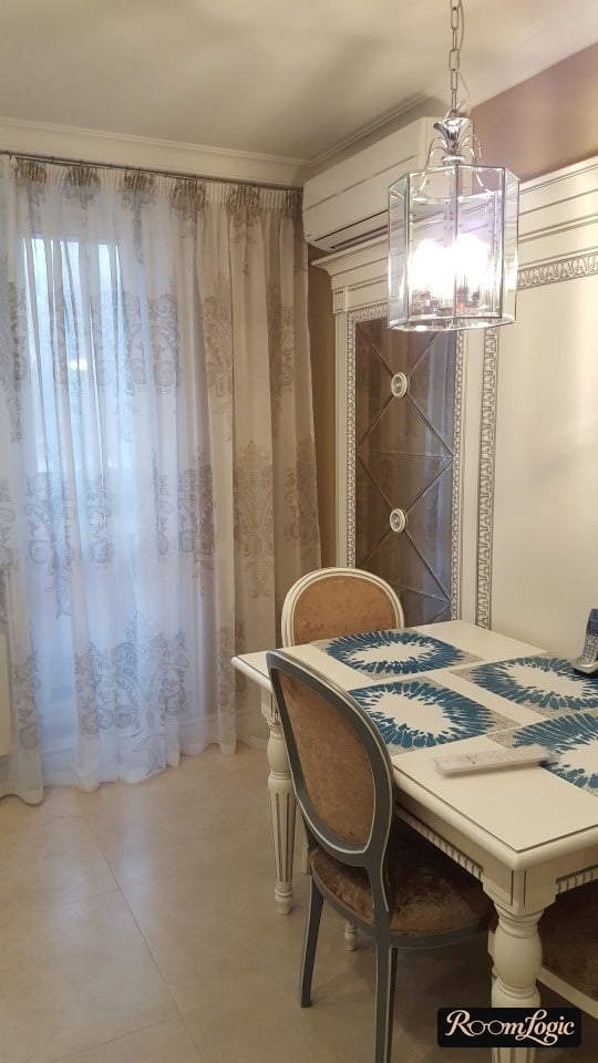 kitchen-dining room with balcony door adorned with sheer curtain