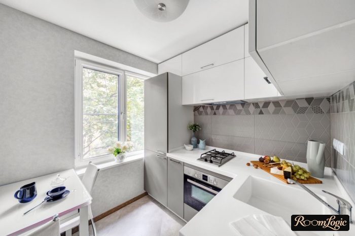 kitchen in a tiny apartment with ceiling-to-floor upper cabinets