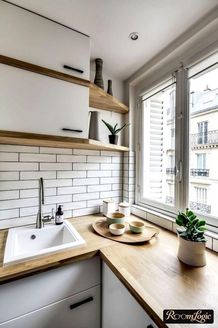 kitchen with white cabinets and backsplash and wooden countertop