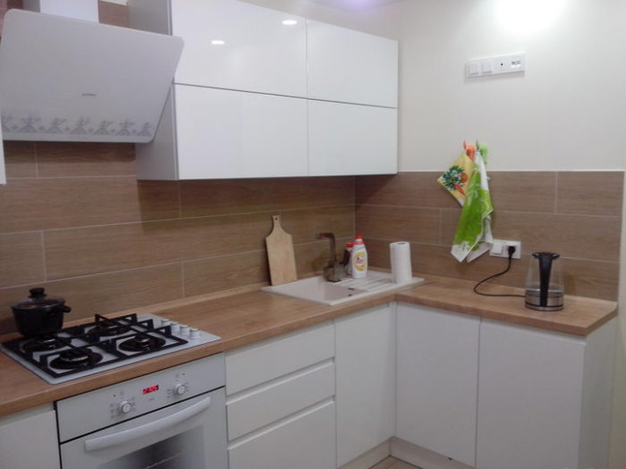kitchen with white glossy cabinets and light wood