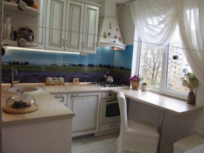 landscape on the kitchen backsplash behind glass