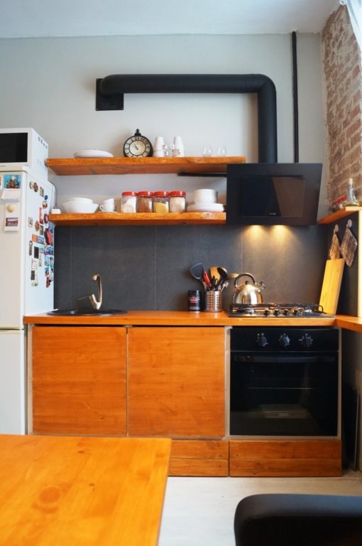 Large square tile on the kitchen backsplash in one row